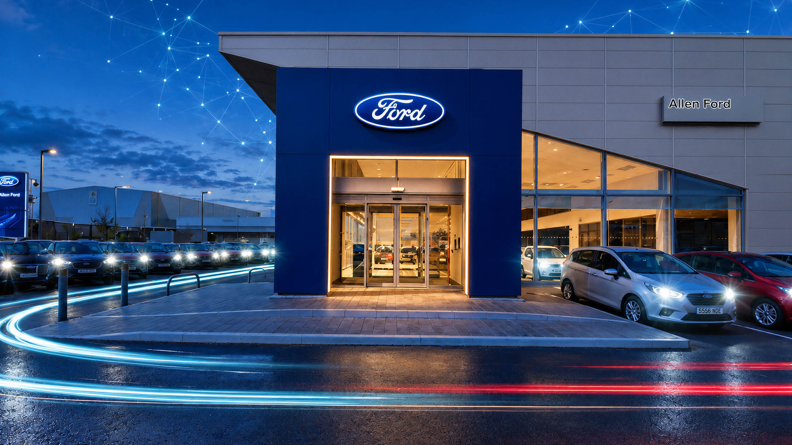 The Allen Ford dealership in the United Kingdom at dusk, forecourt stock lined up outside.